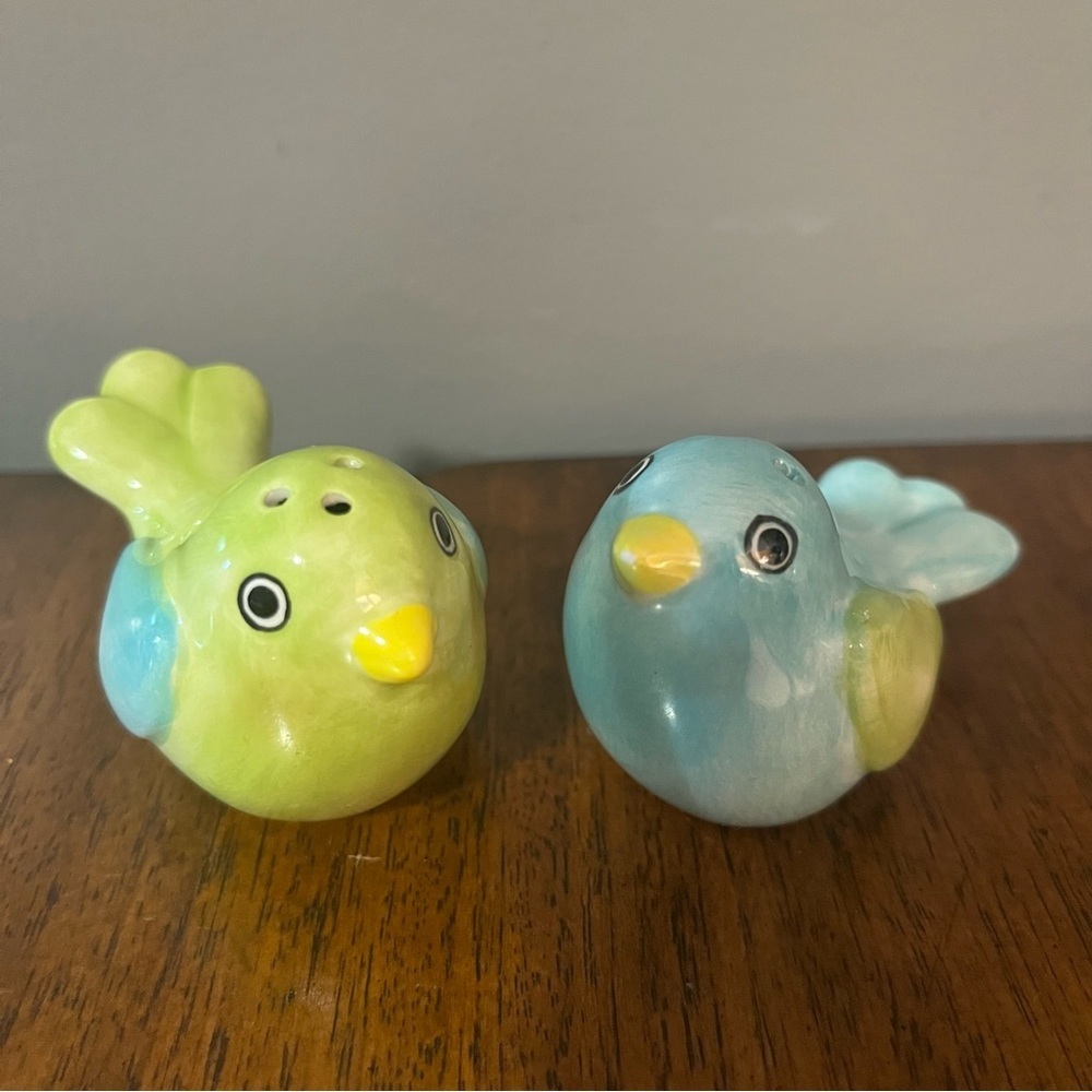 Ceramic Parakeet salt and pepper shakers signed on the bottom.